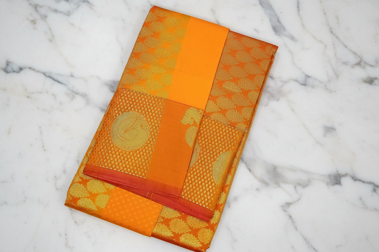 Kanchipuram Pure Silk saree with Intricate Gold Butta Motifs in Marigold Yellow Orange Color