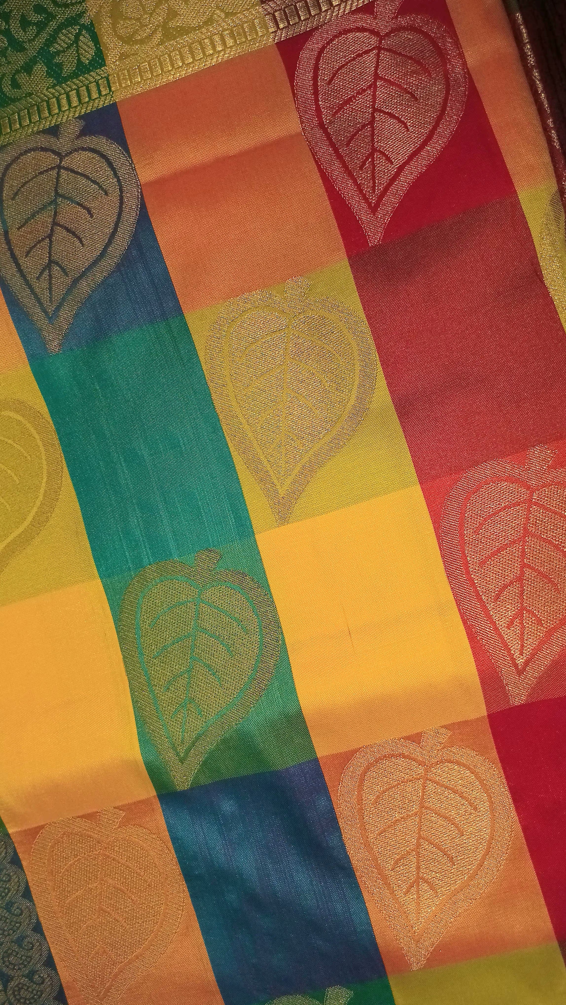 Kanchipuram Pure Silk Saree with Checkered Leaf Butta motifs and luxurious Pallu in Multi Yellow Orange color