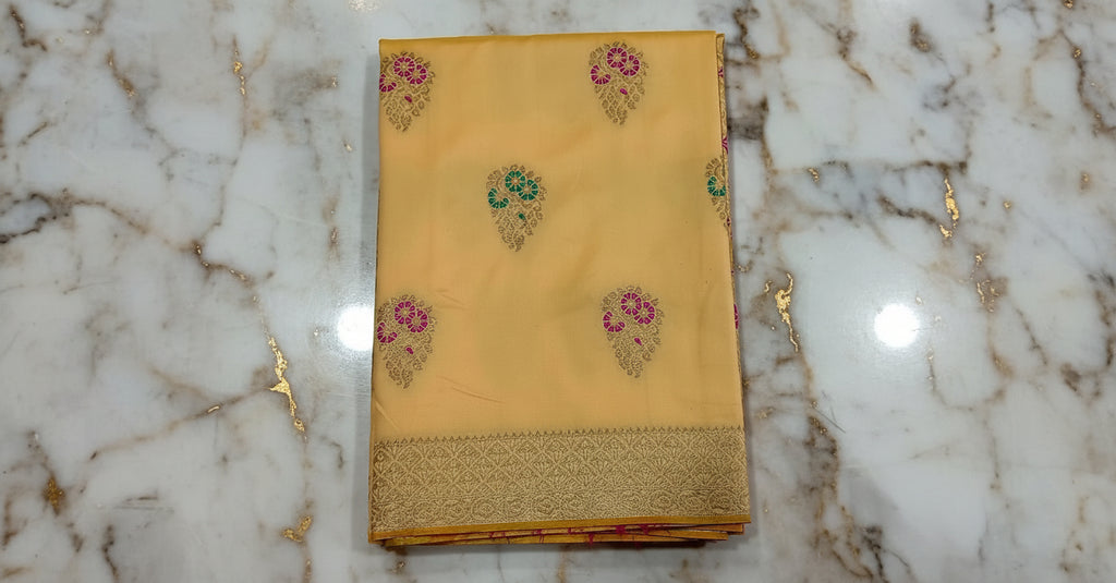 Banarasi Pure Silk Saree with luxurious yet delicate looking Gold Zari Buttas all over the saree and Pallu in Cream color