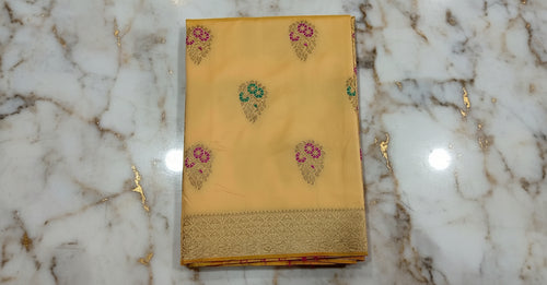 Banarasi Pure Silk Saree with luxurious yet delicate looking Gold Zari Buttas all over the saree and Pallu in Cream color