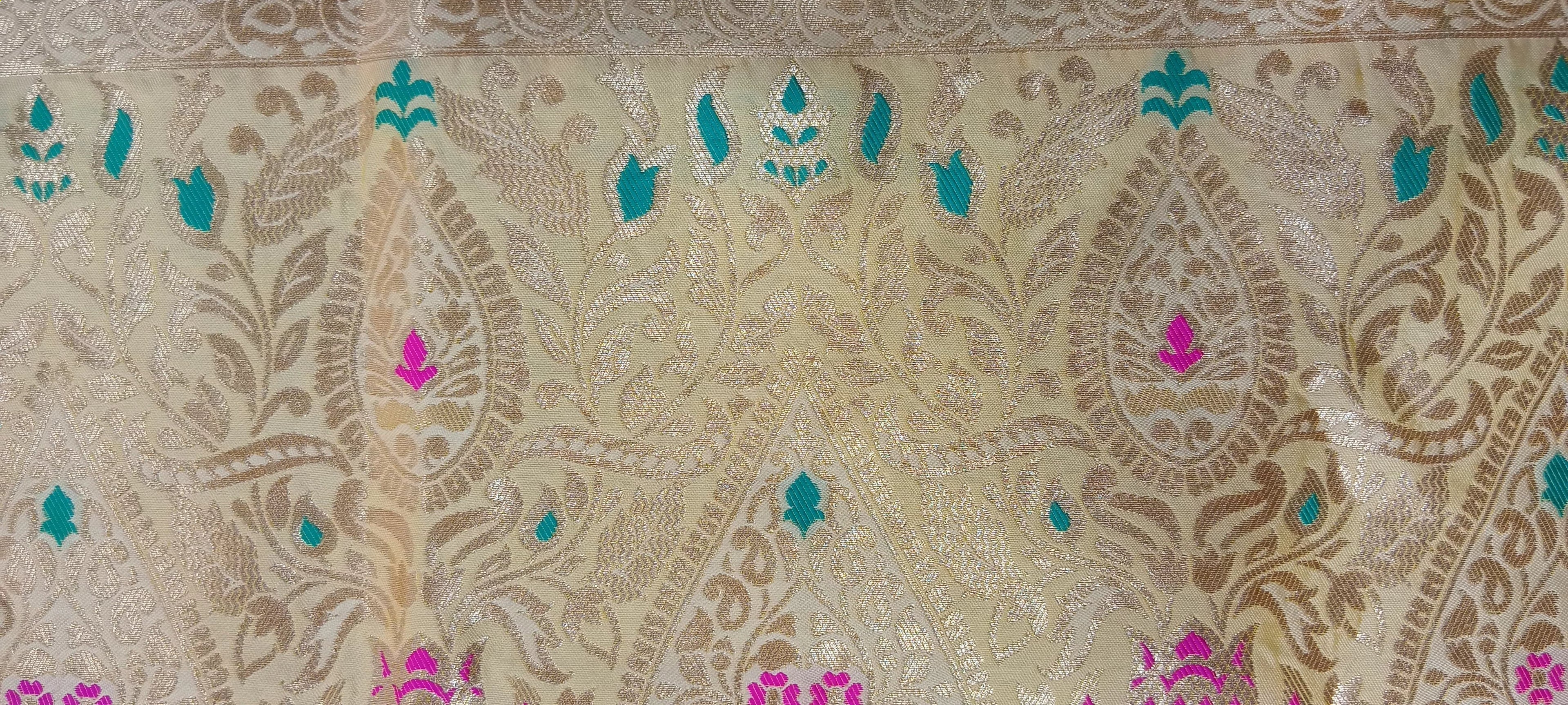 Banarasi Pure Silk Saree with luxurious yet delicate looking Gold Zari Buttas all over the saree and Pallu in Cream color
