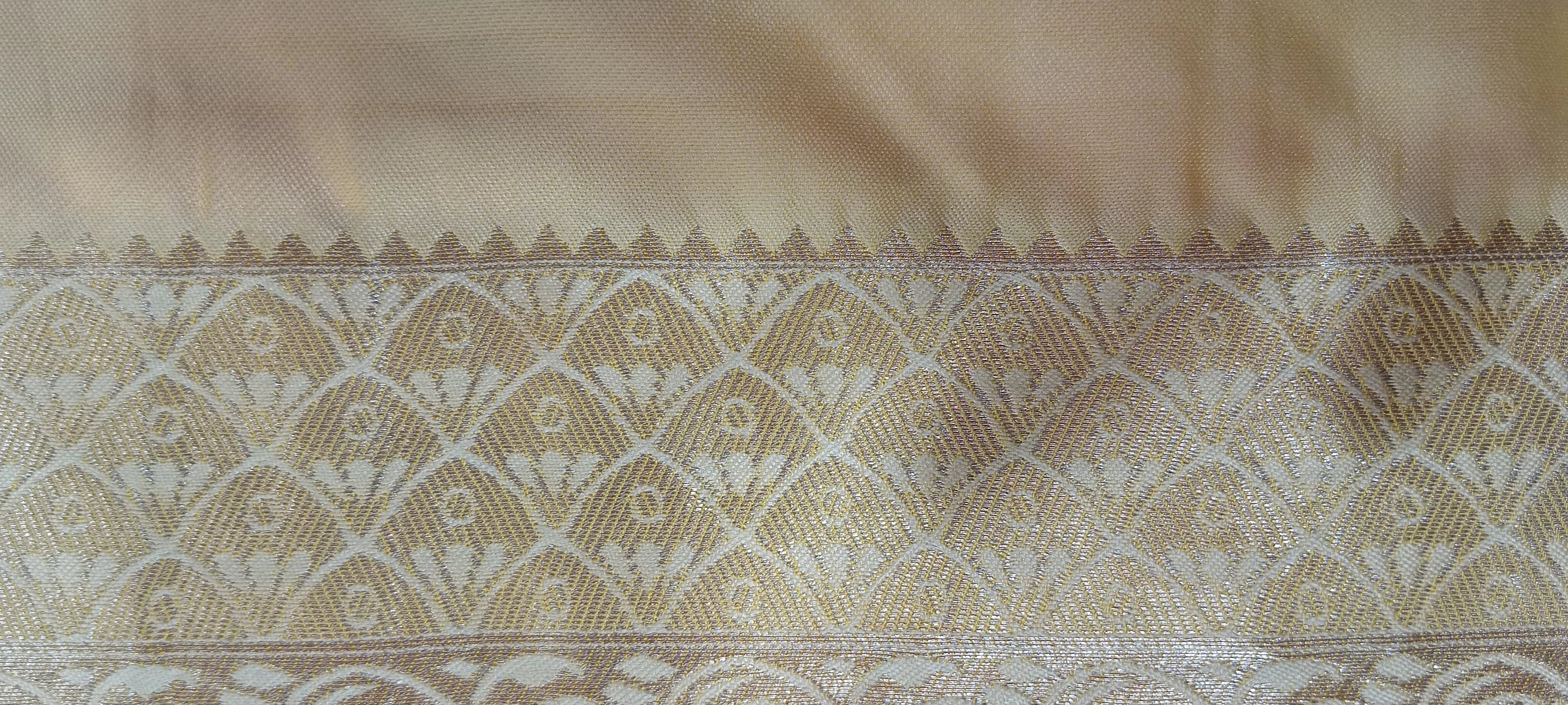 Banarasi Pure Silk Saree with luxurious yet delicate looking Gold Zari Buttas all over the saree and Pallu in Cream color