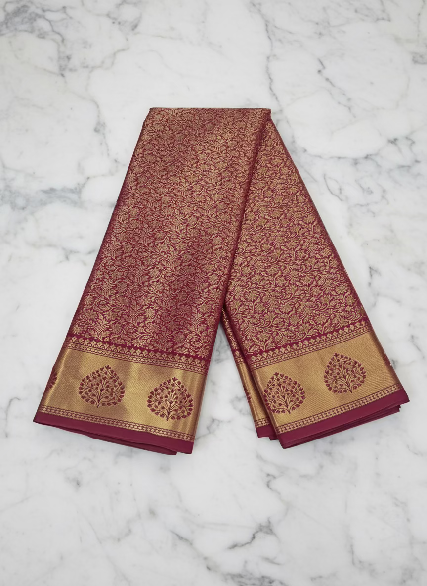 Kanchipuram Pure Silk Saree with detailed Gold Zari Butta motifs and luxurious Pallu with stick on Minakari in Maroon color