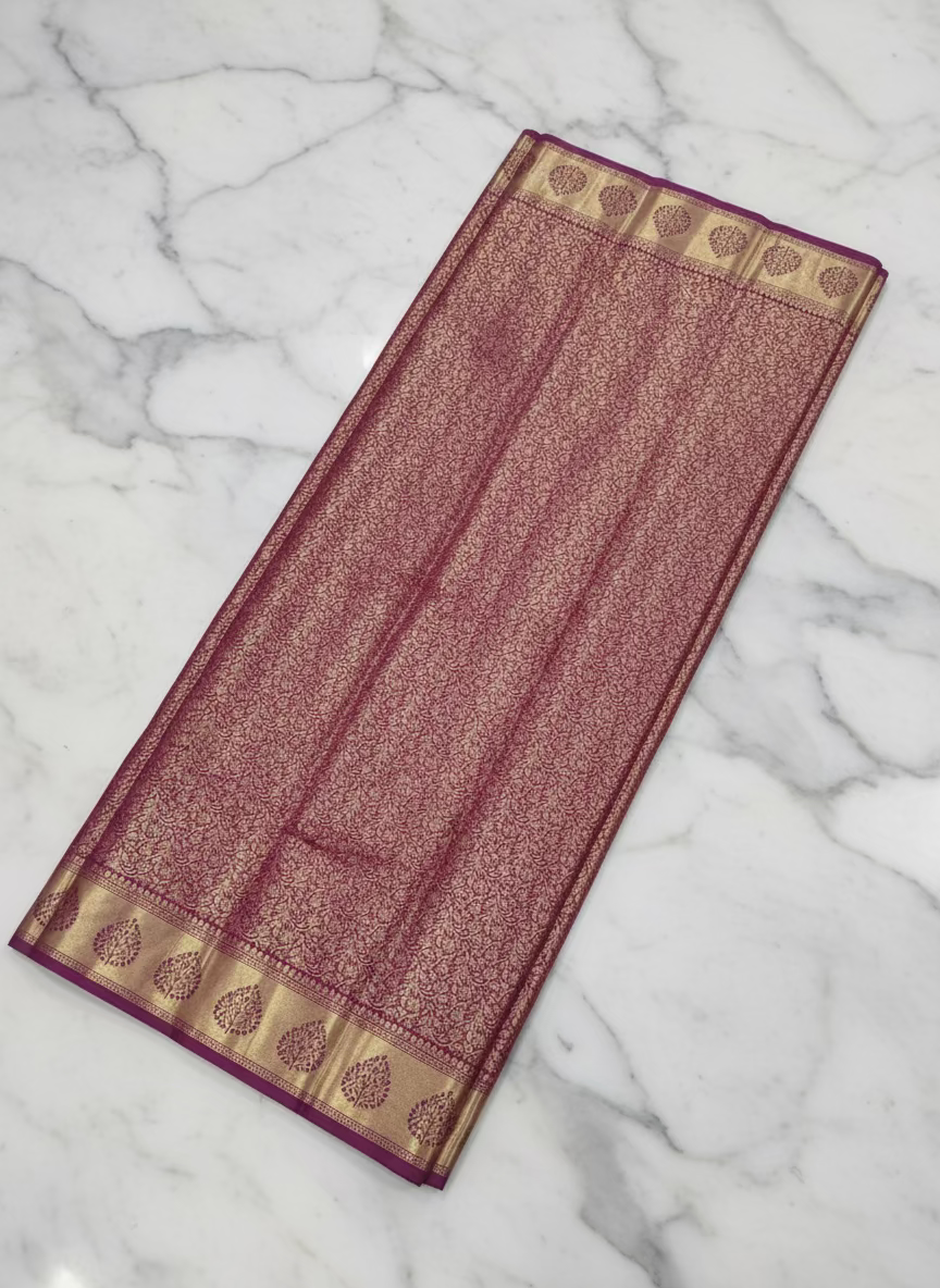 Kanchipuram Pure Silk Saree with detailed Gold Zari Butta motifs and luxurious Pallu with stick on Minakari in Maroon color