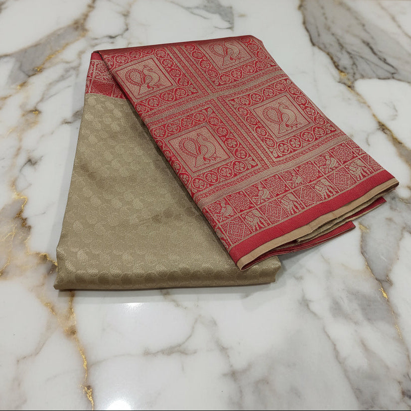 Banarasi Pure Silk Saree with beautiful buttas with pretty gold zari work all over the saree in Sandalwood color with Maroon Red border , wide lower border