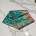 Banarasi Pure Silk Saree with luxurious Gold Zari Floral Buttas all over the saree and Pallu with leaf pattern in Turquoise Green Reddish Maroon Color