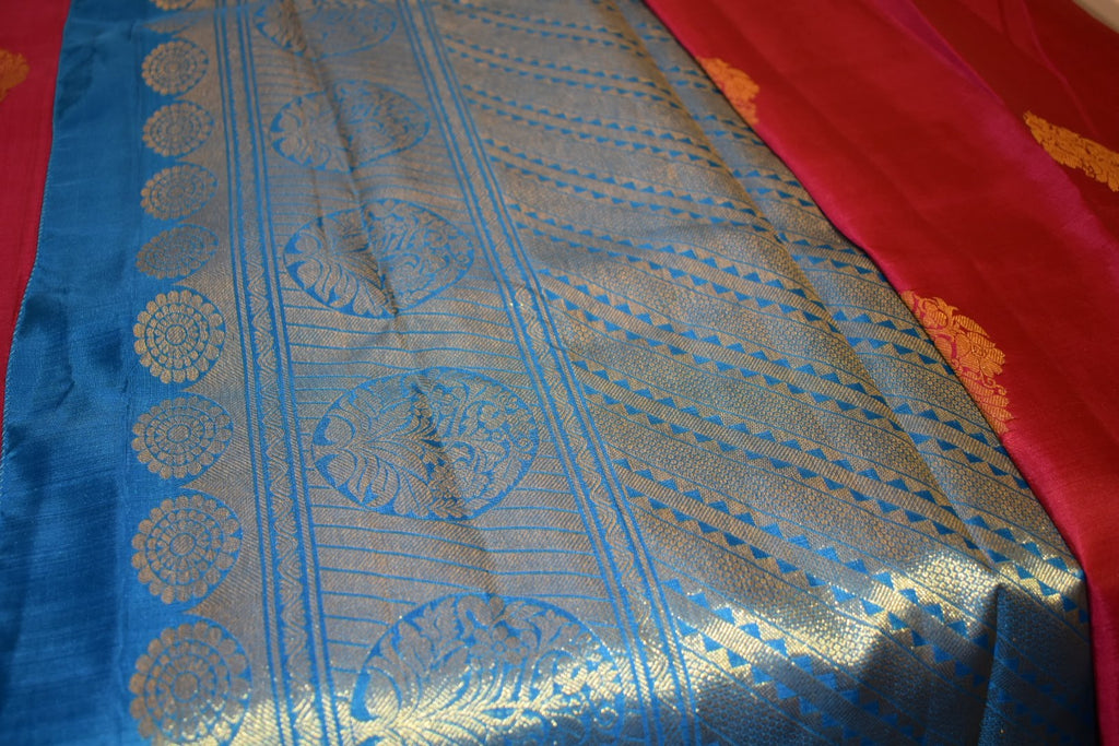 Kanchipuram Pure Silk Saree with bright gold Zari Motifs in Royal Pink color and Contrast Royal Blue Border