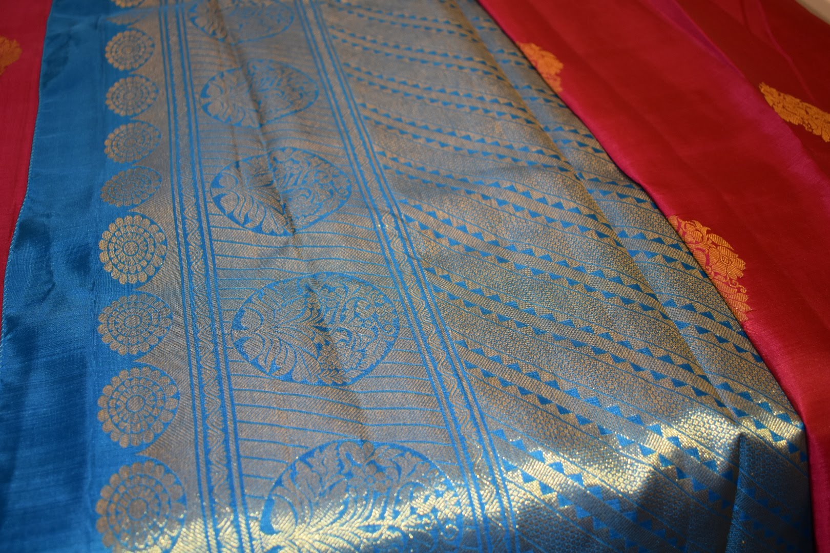Kanchipuram Pure Silk Saree with bright gold Zari Motifs in Royal Pink color and Contrast Royal Blue Border