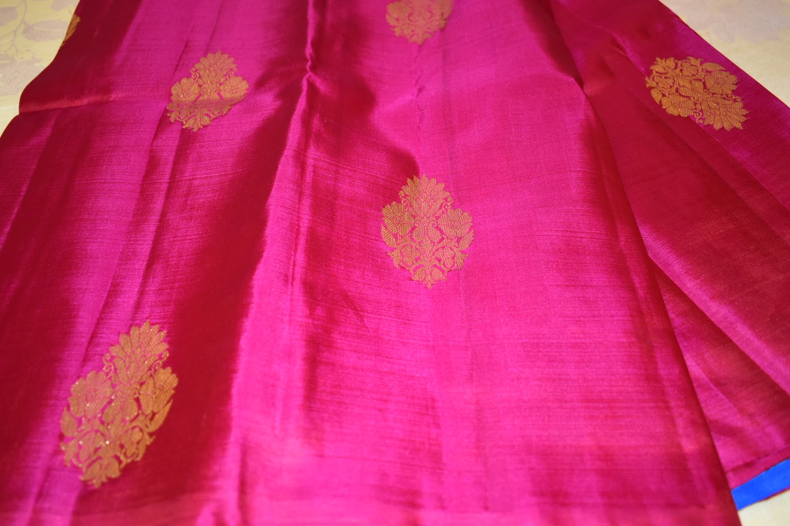 Kanchipuram Pure Silk Saree with bright gold Zari Motifs in Royal Pink color and Contrast Royal Blue Border