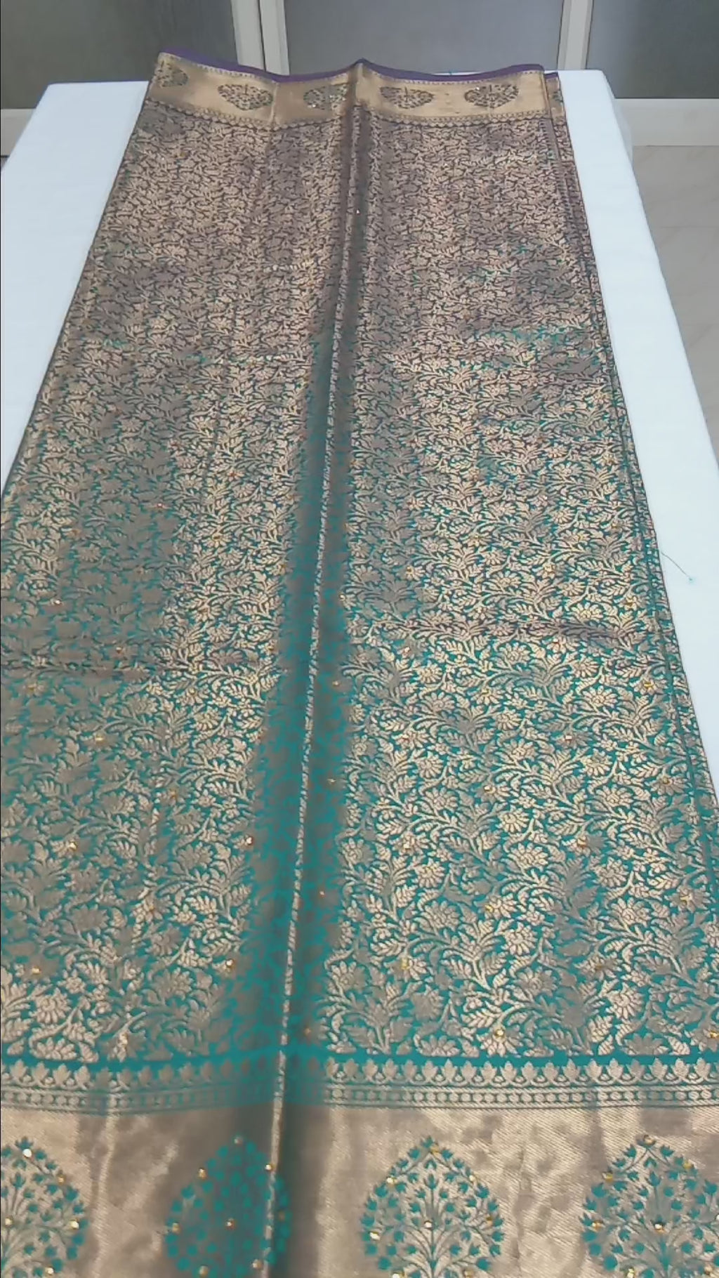 Kanchipuram Pure Silk Saree with detailed Gold Zari Butta motifs and luxurious Pallu with stick on Minakari in Bluish Green color